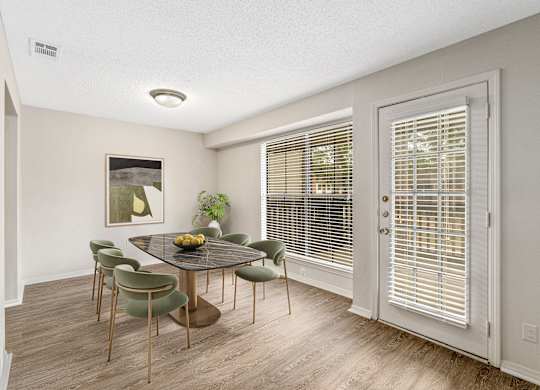 Large dining area in the model with staged six seater dining table at Oakley at Hillcrest