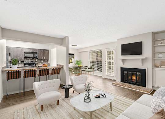 A modern open concept living area with breakfast bar and fireplace at Oakley at Hillcrest in west mobile, al