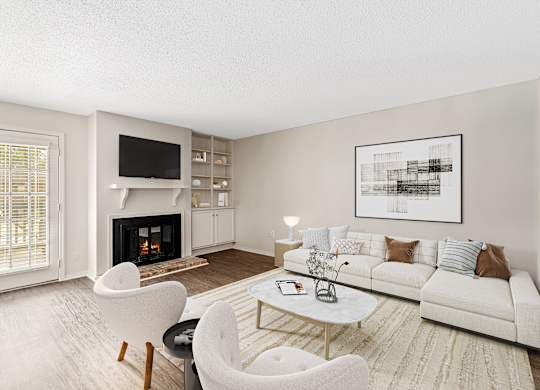 A large living room with sectional sofa and two chairs, fireplace and door to the patio at Oakley at Hillcrest in west mobile, al