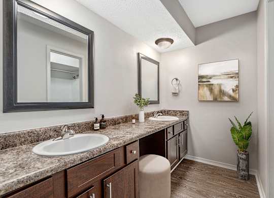 Primary bathroom with double vanities and large makeup vanity area at Oakley at Hillcrest in west mobile, al