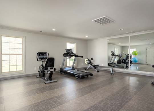 A spacious home gym with a variety of exercise equipment.