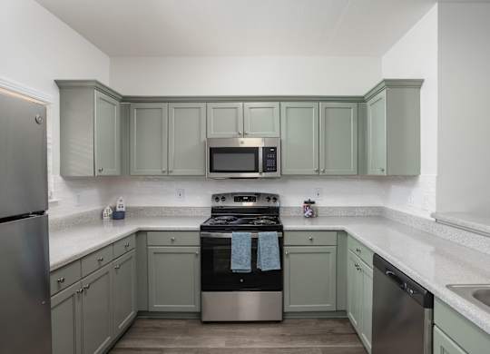 A kitchen with a stove, oven, and refrigerator.