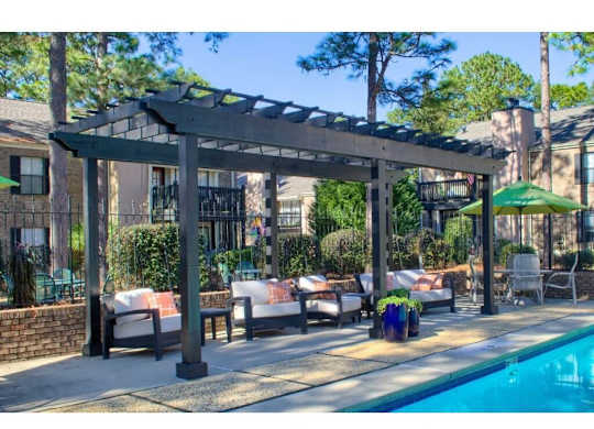 a pergola next to a swimming pool at The Oakley at Hillcrest in Mobile, AL