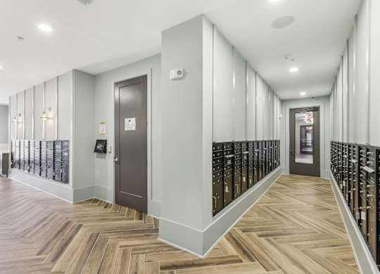 a long hallway with wooden floors and a door