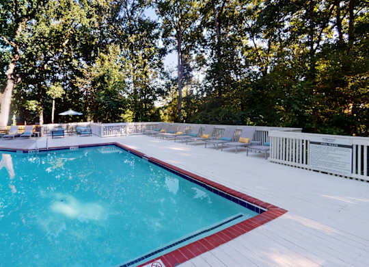 Sparkling pool with expansive sundeck and chaise lounges at Summerchase at Riverchase in Hoover, AL