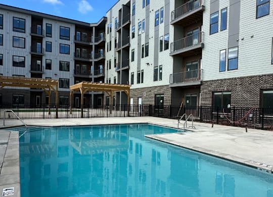 A sparkling swimming pool and access to the grilling pergola at the Fitzroy Apartments in Birmingham, Alabama.