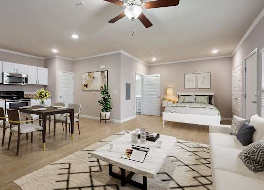 a living and dining room area with a bed in the background and a ceiling fan overhead