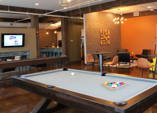 Clubhouse gameroom with pool table, full kitchen, and social lounge. at Promenade at Founders Square Apartments in Indianapolis, IN