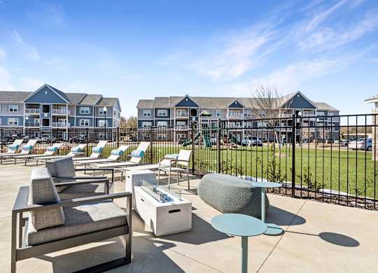 A sunny day at a resort with chairs and tables set up.