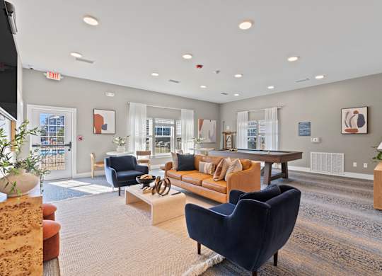 A spacious living room with a variety of furniture and decor.