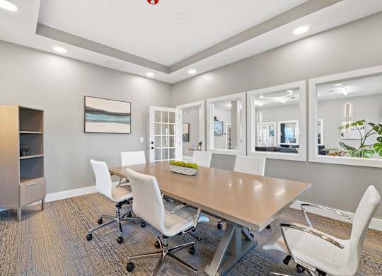 A conference room with a long table and chairs.