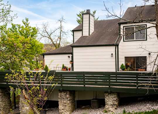 Clubhouse with wooden deck overlooking community lake at Saddlebrook at Tates Creek Apartments in Lexington, KY