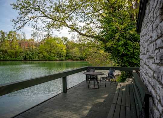 A wooden deck overlooking the community lake at Saddlebrook at Tates Creek Apartments in Lexington, KY