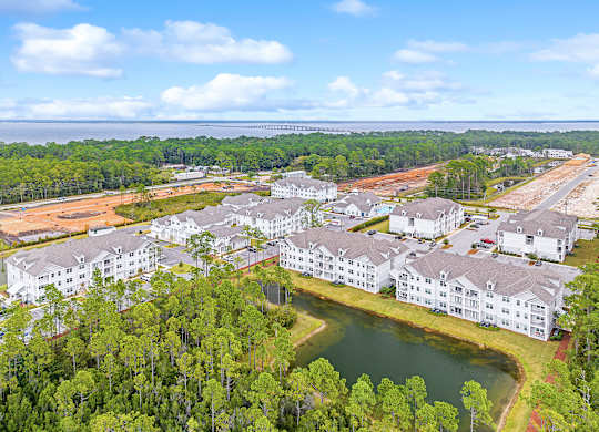 A bird's eye view of a resort with a lake and buildings.