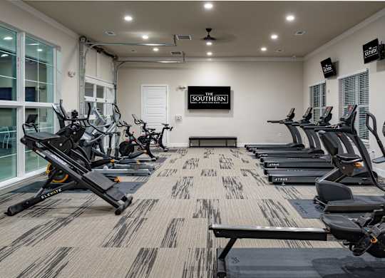 Fitness center with large windows and natural lighting at Southern at Santa Rosa