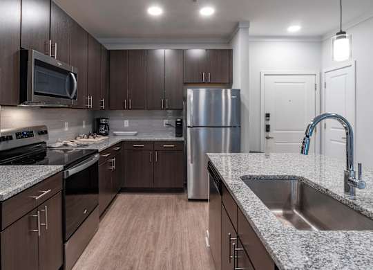 Spacious kitchen with large island and granite countertops Costal Model floorplan