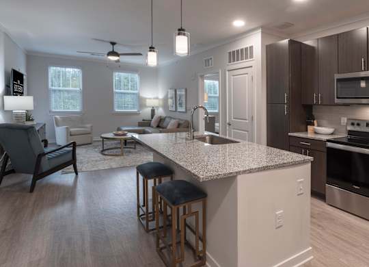 Large kitchen island open to the living room area in the Coastal floorplan at Southern at Santa Rosa