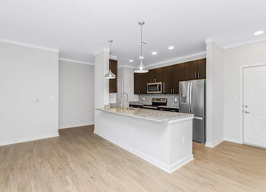 Large kitchen island with pendant lighting at Southern at Santa Rosa