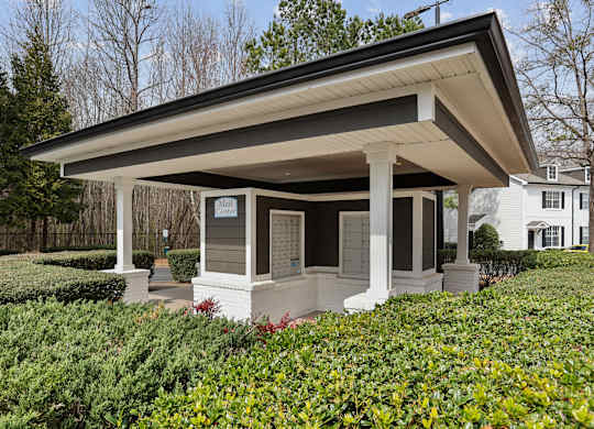 A small white house with a porch and a covered entrance.