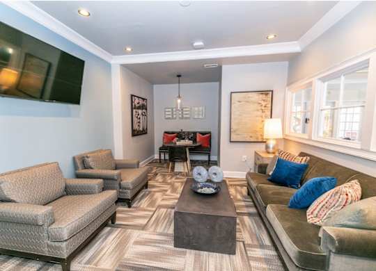 A living room with a grey couch, a brown armchair, and a coffee table.