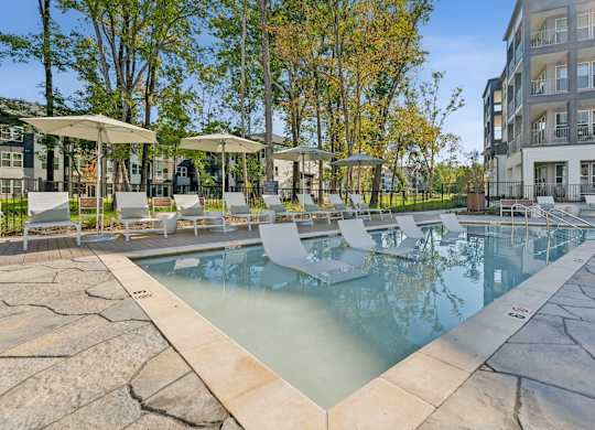 our apartments have a resort style pool with lounge chairs and umbrellas