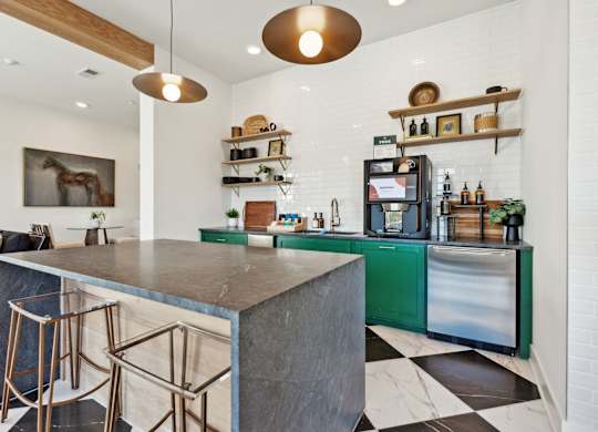 a kitchen with a marble counter top and green cabinets