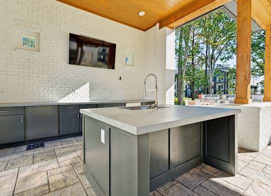 a large kitchen with stainless steel counter tops and a large window