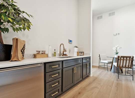 a kitchen with a counter top and a dining room with a table