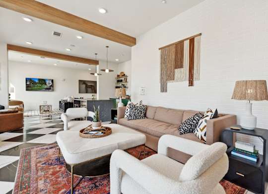 a living room filled with furniture and a checkered floor