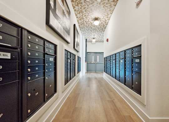 a long hallway with a bunch of lockers in a room with wood floors