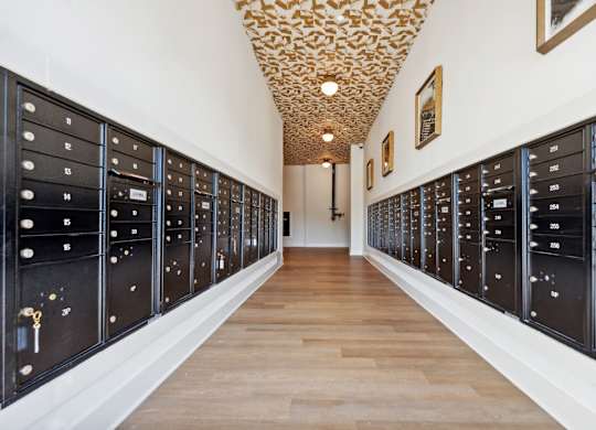 a long hallway with vaulted ceilings and a row of lockers