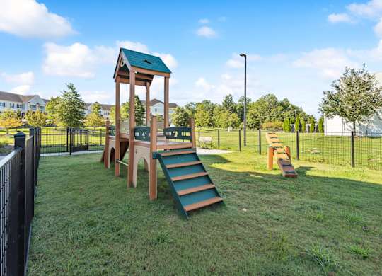 a playground at a park with a tall wooden tower