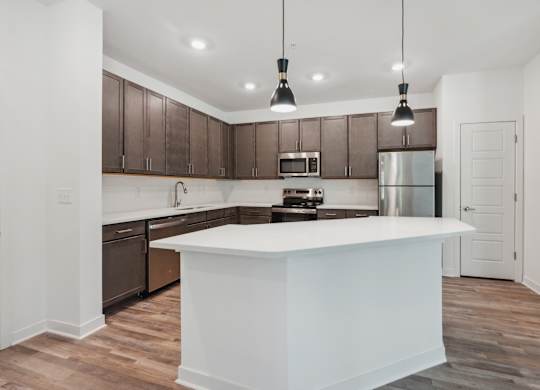 a kitchen with a large white counter top and