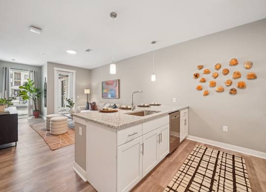 A kitchen with a white counter top and cabinets.