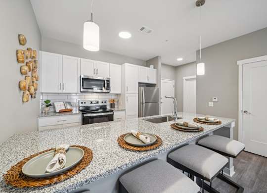 A kitchen with a granite countertop and a white oven.
