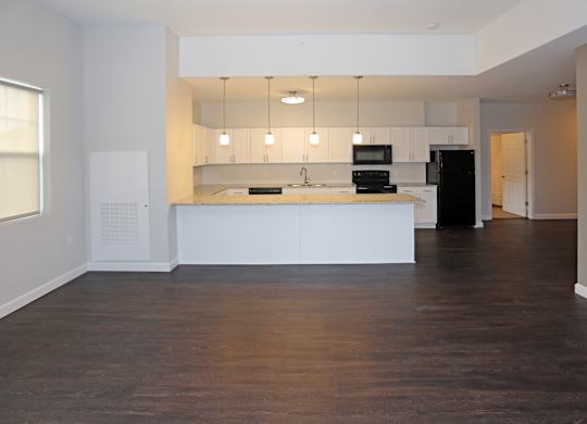 A kitchen with white cabinets and black appliance at Promenade at Founders Square Apartments in Indianapolis, IN