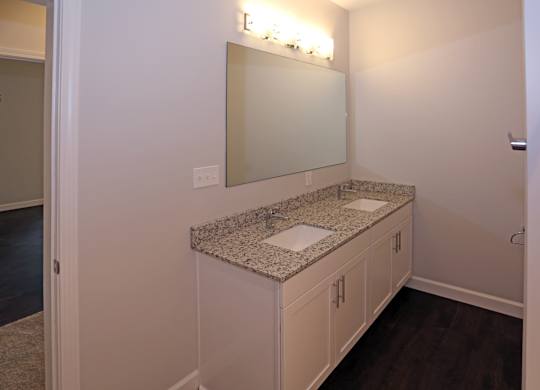 double vanity with granite countertops and undermount sinks at Promenade at Founders Square Apartments in Indianapolis, IN