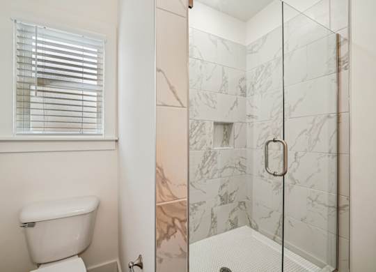 Bathroom with glass door shower at Turnberry Park Apartments in Gardendale, AL
