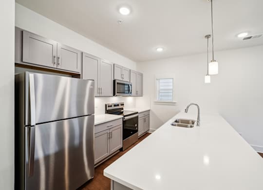 Modern kitchen with stainless appliances at Turnberry Park Apartments in Gardendale, AL