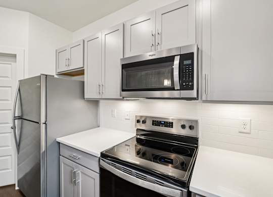 Modern kitchen with stainless appliances at Turnberry Park Apartments in Gardendale, AL