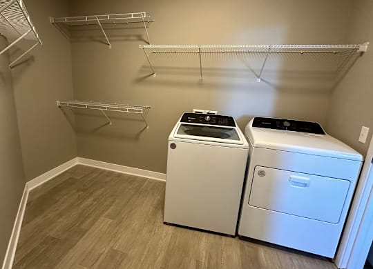 A laundry room with a washer and dryer at The Fitzroy Apartments in Birmingham, AL