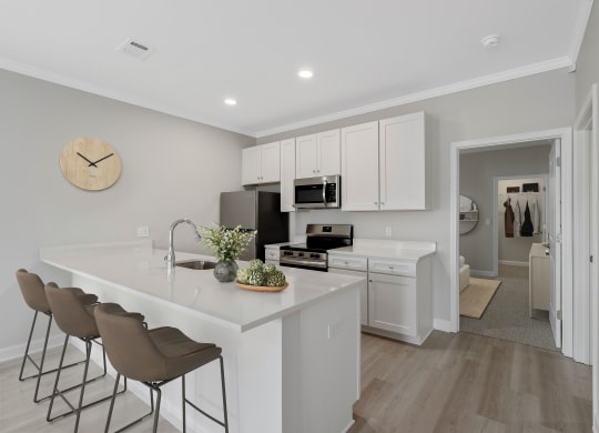 a kitchen with white cabinets and a white counter top at The Cottages at Foley Farms apartments in Foley, AL