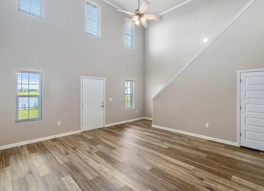 a living room with a vaulted ceiling and hardwood floors