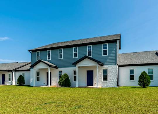 a house with blue siding and a gray roof
