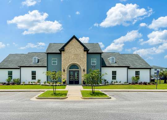 a house with a cloudy blue sky in the background