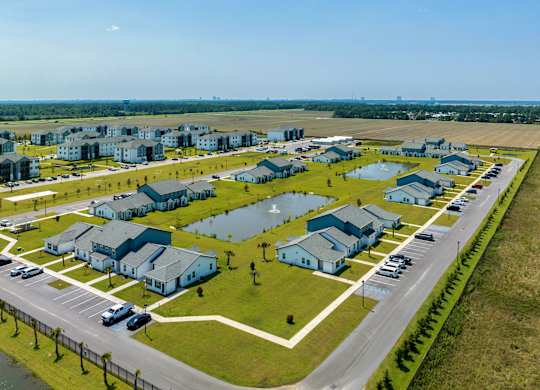 a row of houses on a grassy field