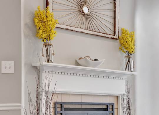 Living room with a fireplace and wood-style flooring at Village at Caldwell in Birmingham, AL