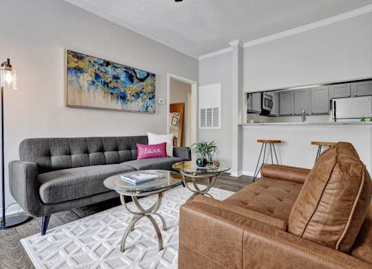 A living room with wood-style flooring at Village at Caldwell Apartments in Birmingham, AL