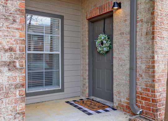 A grey door with a wreath on it at Village at Caldwell Mill in Birmingham, AL