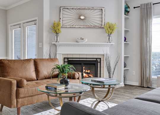 Living room with plank flooring and fireplace at Village at Caldwell Mill in Birmingham, AL